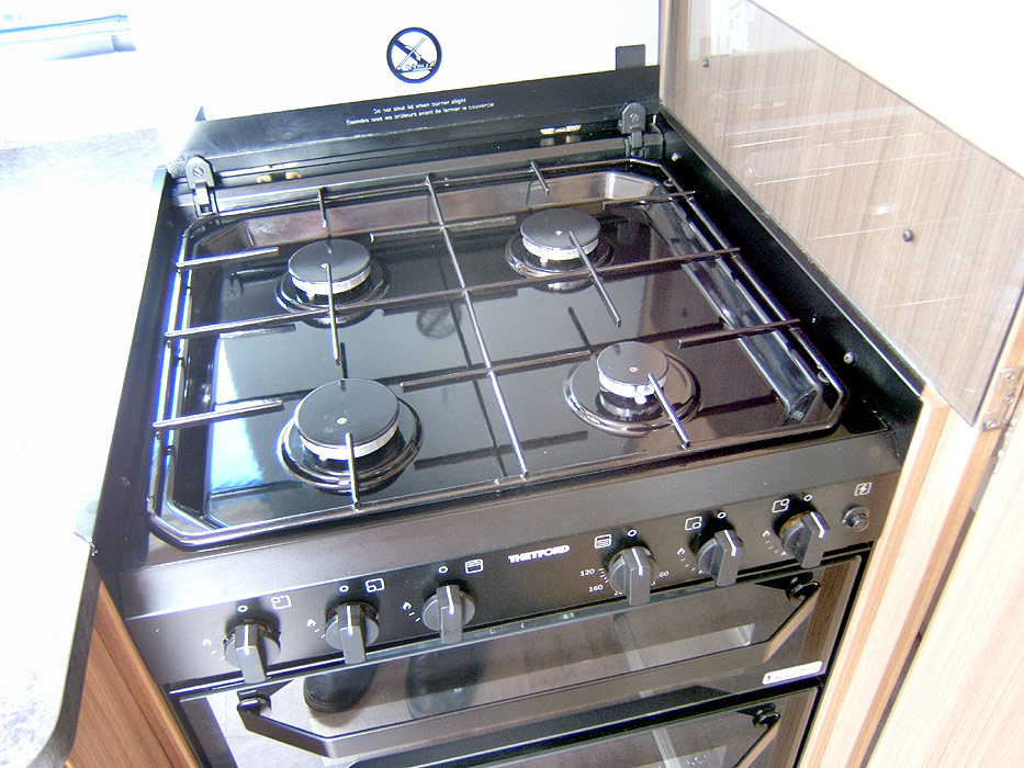 The Dometic hob unit with 3 gas burners and 1 electric hotplate.